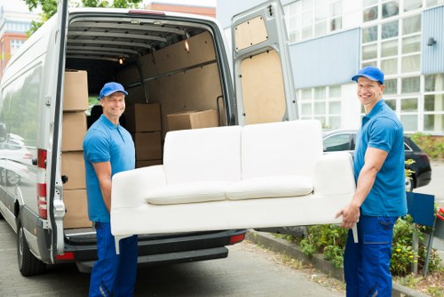 Removal van and movers working in a residential Barnes street