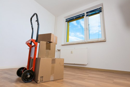 Movers carrying furniture through a Barnes property